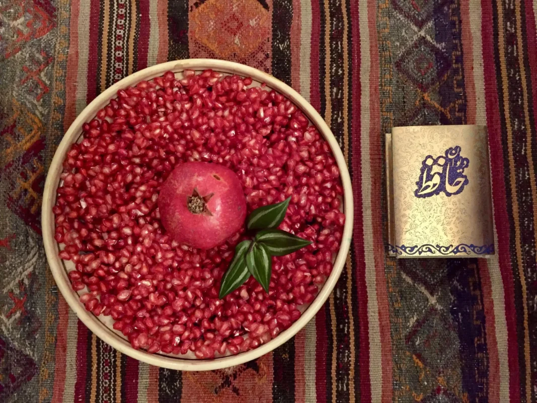 Hafez poetry book and pomegranate during Yalda Night